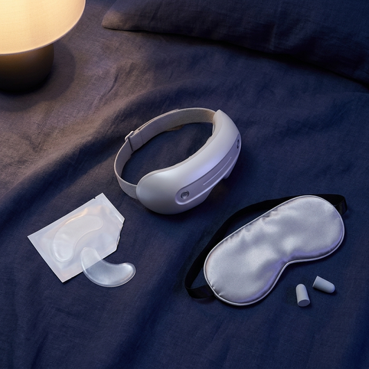 The Gift Set — Duskala massager, cooling patches, and silk sleep mask on indigo linen